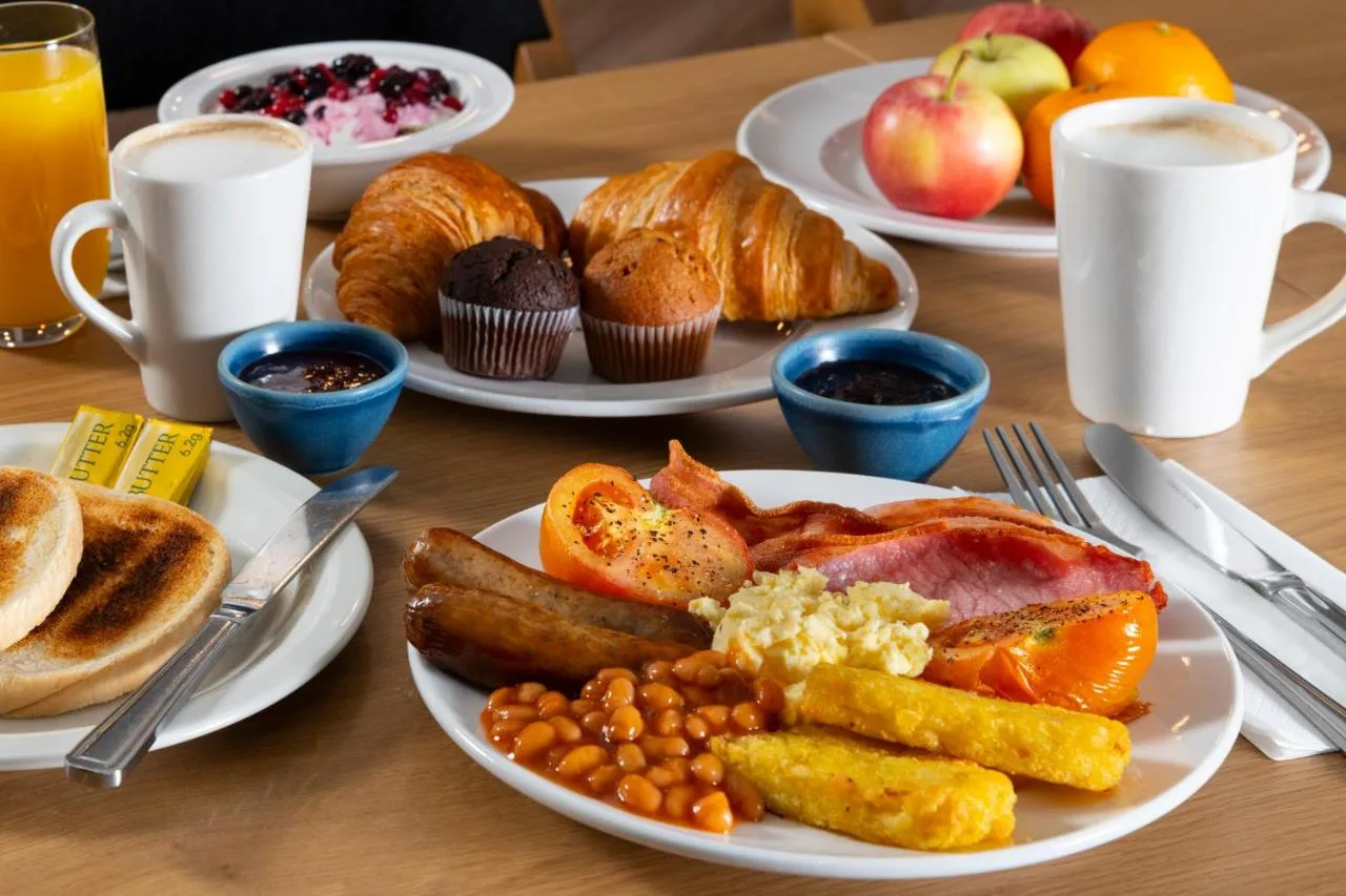 a table with plates of breakfast food on it at Holiday Inn Express Bristol City Centre by IHG in Bristol